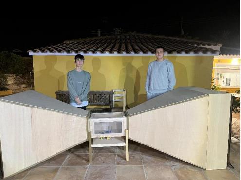 Jan Kazimierczak and teammate Tobias Van Bavel standing behind the custom wind tunnel